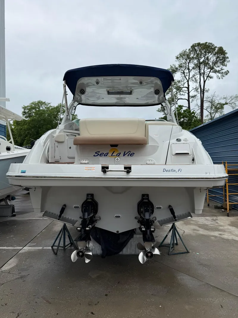 Slide: The Image of 2019 Crownline 350 SY boat docked, rear view, with dual propellers and canopy. - 11