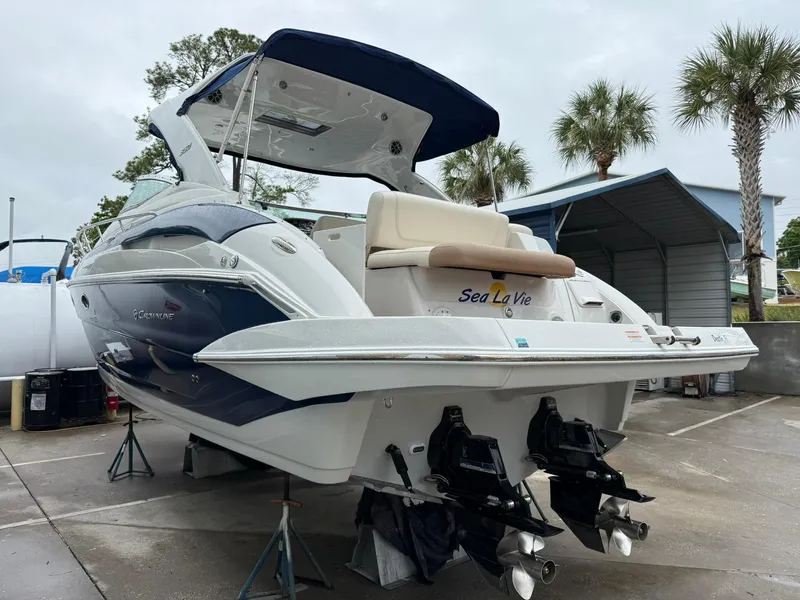 Slide: The Image of 2019 Crownline 350 SY boat on dry dock, featuring dual engines and sleek design. - 12
