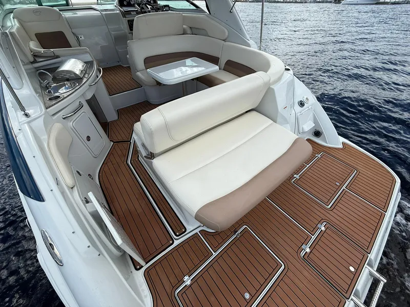 Slide: The Image of 2019 Crownline 350 SY yacht interior with luxurious seating and wooden flooring on the water. - 14