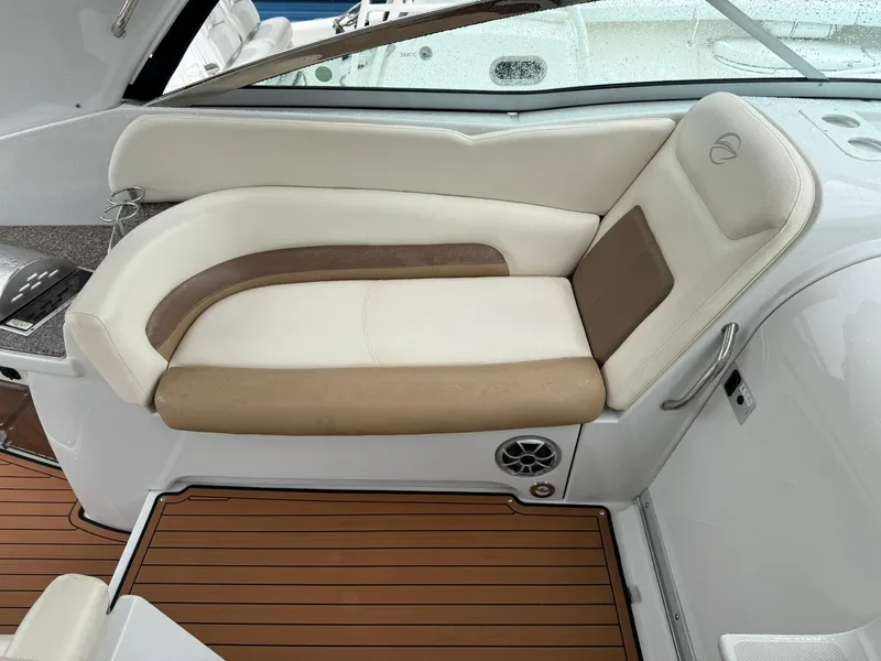 Slide: The Image of 2019 Crownline 350 SY boat interior with beige and white seating, wood-style flooring. - 19