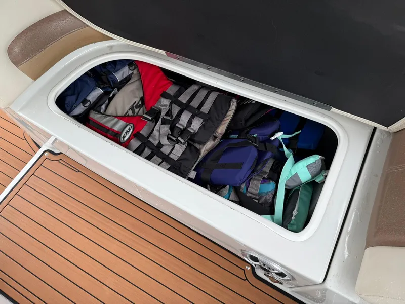 Slide: The Image of Storage compartment on 2019 Crownline 350 SY boat with life jackets inside. - 20