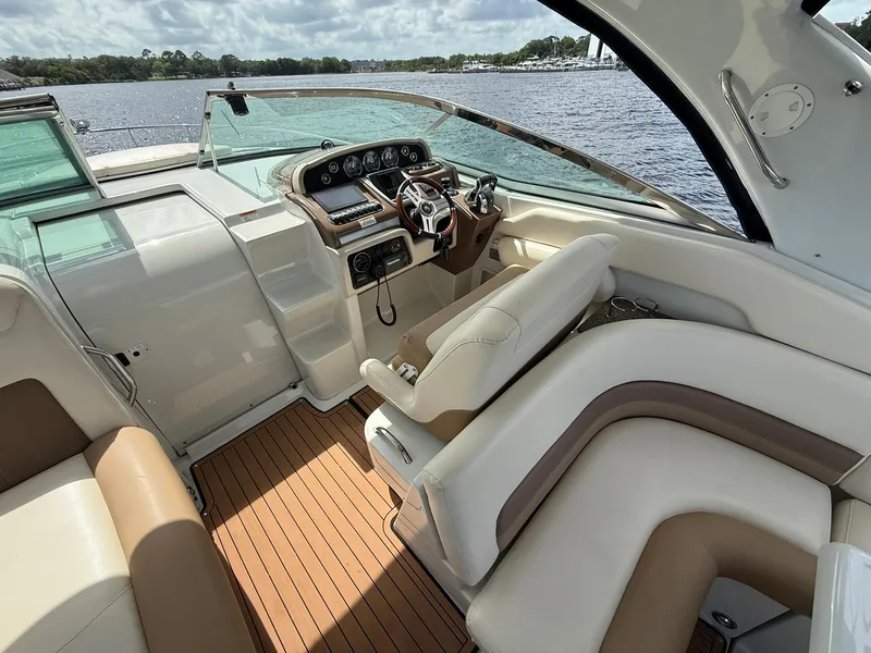 Slide: The Image of 2019 Crownline 350 SY boat interior with luxurious seating and modern dashboard. - 21