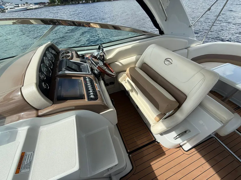 Slide: The Image of 2019 Crownline 350 SY boat interior with helm, steering wheel, and seating. - 22