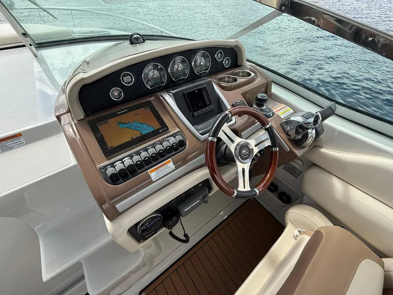 Slide: The Image of 2019 Crownline 350 SY helm with navigation system and steering wheel, overlooking water. - 23