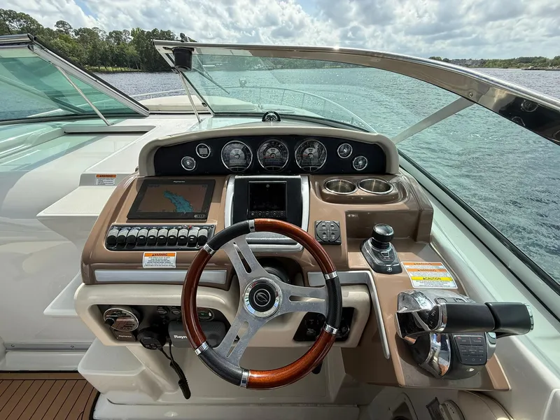 Slide: The Image of Helm of 2019 Crownline 350 SY boat with steering wheel and navigation controls. - 24
