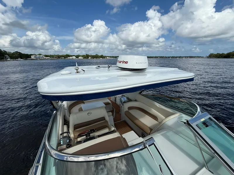 Slide: The Image of 2019 Crownline 350 SY boat on water, featuring spacious seating and advanced navigation equipment. - 28