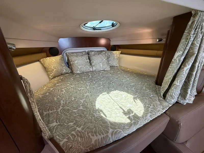 Slide: The Image of Luxurious cabin interior of 2019 Crownline 350 SY yacht with elegant bedding and porthole. - 30