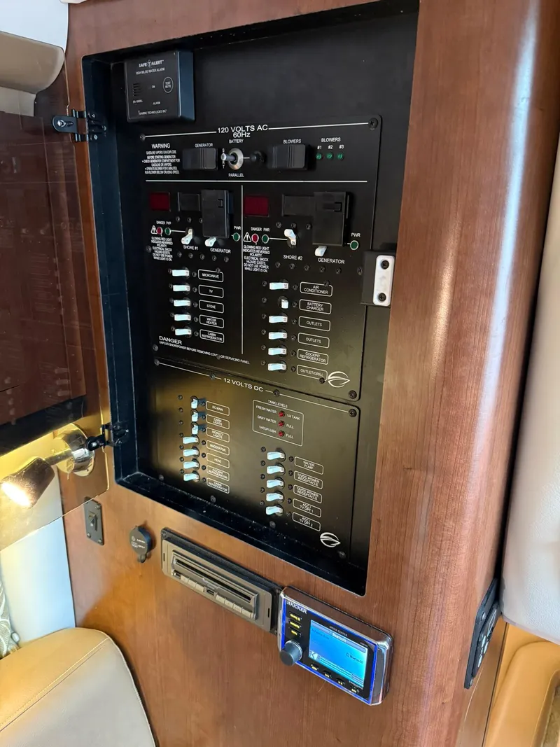 Slide: The Image of Control panel inside 2019 Crownline 350 SY boat, featuring switches and electronic display. - 32