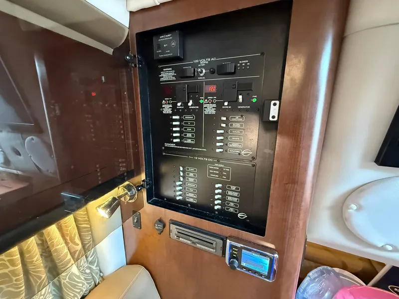 Slide: The Image of Electrical control panel inside 2019 Crownline 350 SY boat cabin. - 33