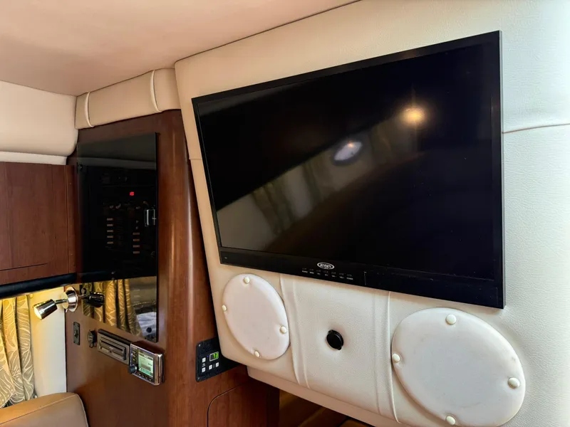 Slide: The Image of Interior of 2019 Crownline 350 SY yacht featuring a mounted TV and control panel. - 35