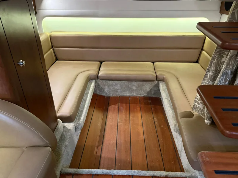 Slide: The Image of 2019 Crownline 350 SY interior with beige seating and wooden flooring. - 36