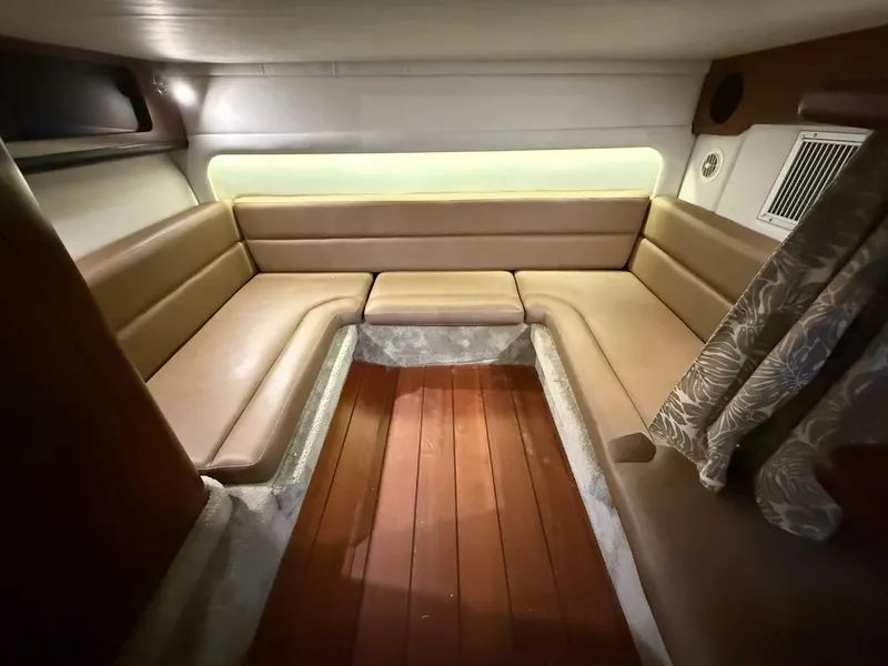 Slide: The Image of 2019 Crownline 350 SY cabin interior with beige seating and wood flooring. - 37