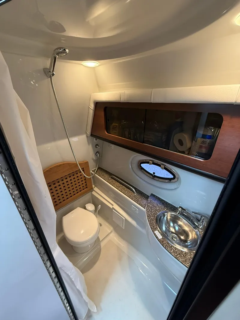 Slide: The Image of 2019 Crownline 350 SY yacht bathroom with shower, sink, and storage. - 39