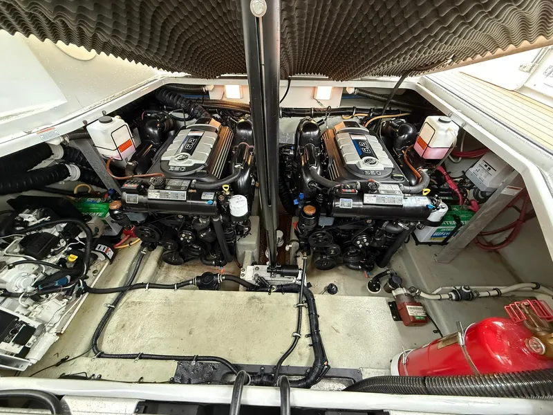 Slide: The Image of Engine room of a 2019 Crownline 350 SY boat, featuring dual engines and equipment. - 42