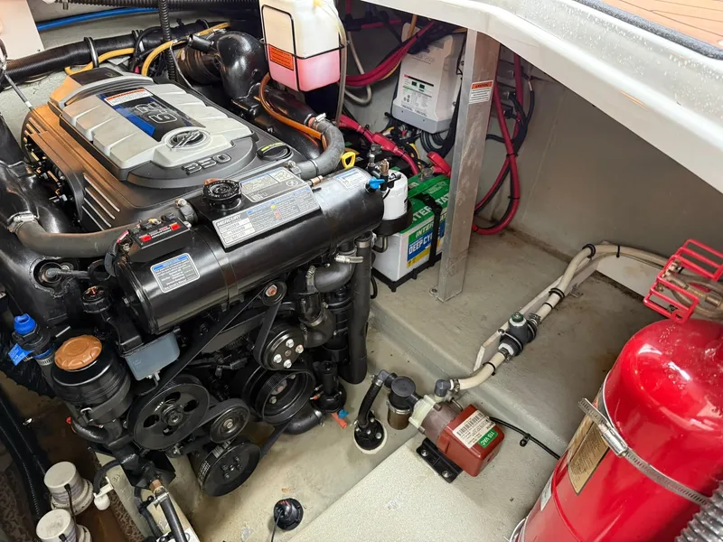 Slide: The Image of Engine compartment of a 2019 Crownline 350 SY boat, featuring detailed mechanical components. - 44