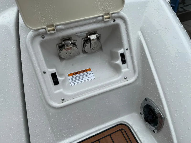 Slide: The Image of 2019 Crownline 350 SY boat electrical panel with warning label and water droplets. - 45