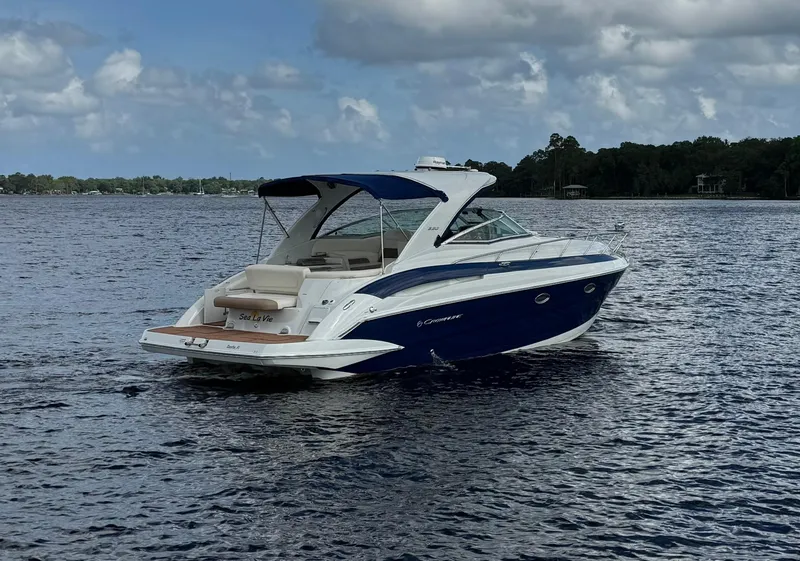 Slide: The Image of 2019 Crownline 350 SY boat on calm water under cloudy sky. - 7