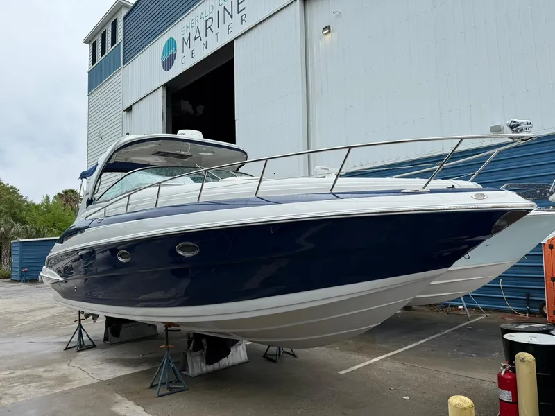 Slide: The Image of 2019 Crownline 350 SY boat docked at a marine center, showcasing sleek design and modern features. - 8