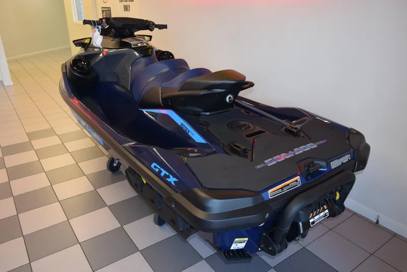 Slide: The Image of 2024 Sea-Doo GTX 300 jet ski in showroom, blue and black design. - 4