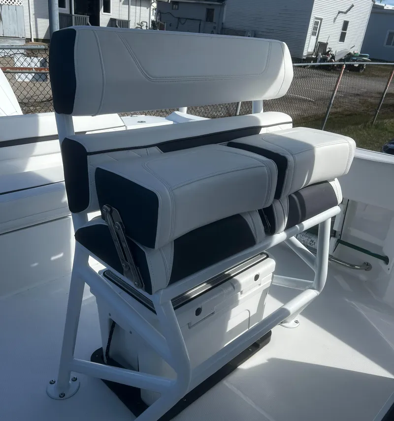 Slide: The Image of 2022 Blackfin 222 CC boat seating with white and black cushioned design. - 16