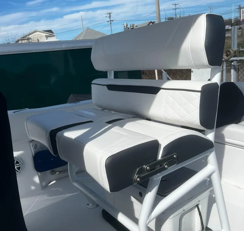 Slide: The Image of 2022 Blackfin 222 CC boat seating with white and black upholstery. - 19