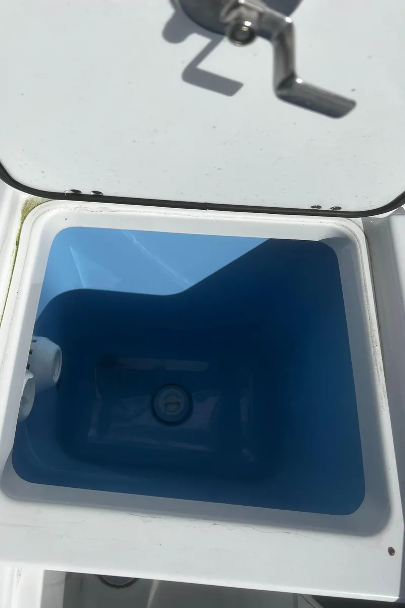Slide: The Image of 2022 Blackfin 222 CC boat livewell with open lid, showcasing interior. - 30