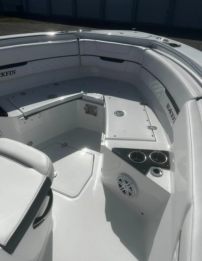 Slide: The Image of 2022 Blackfin 222 CC boat interior with seating, cup holders, and speaker. - 33