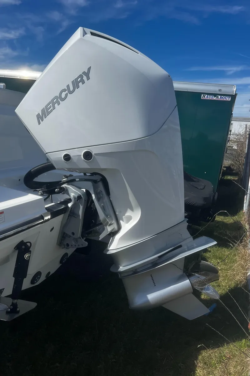 Slide: The Image of 2022 Blackfin 222 CC with Mercury outboard engine, parked on grass. - 40