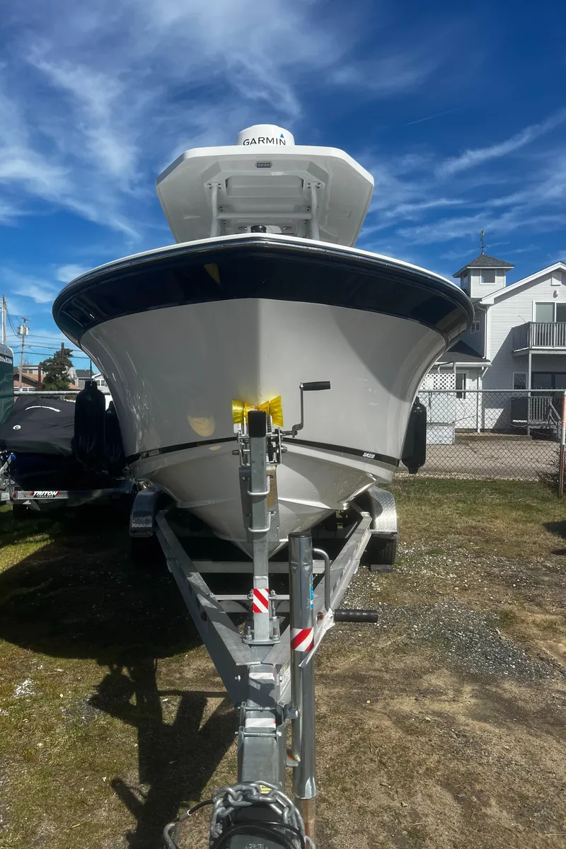 Slide: The Image of 2022 Blackfin 222 CC boat on trailer under clear blue sky. - 43