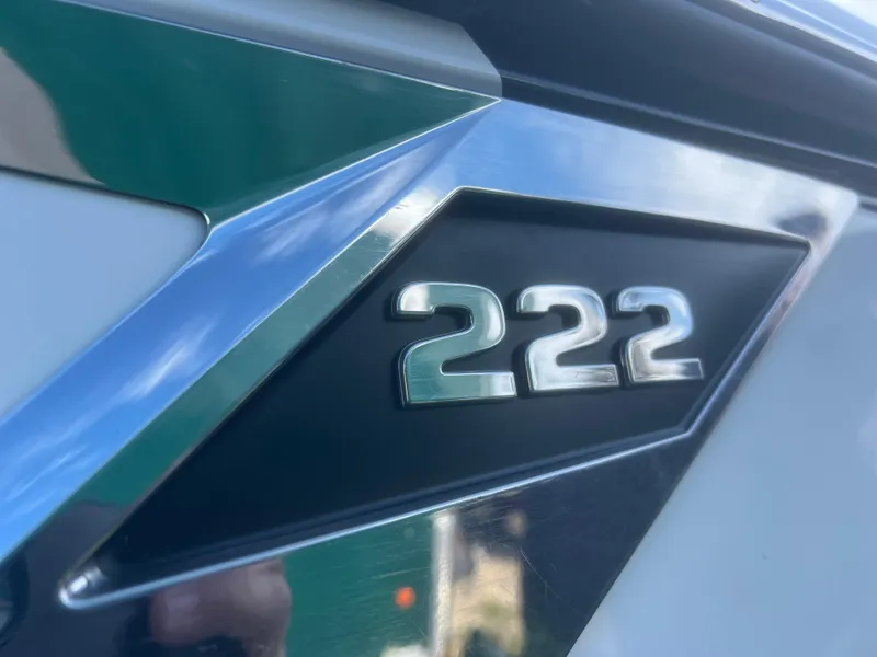 Slide: The Image of 2022 Blackfin 222 CC boat emblem with metallic finish and sleek design. - 8