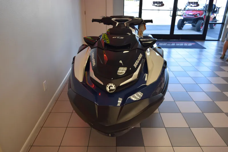 Slide: The Image of 2024 Sea-Doo GTX Limited 300 jet ski displayed indoors on tiled floor. - 3