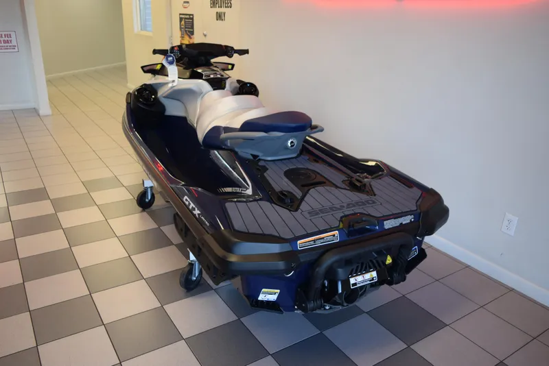 Slide: The Image of 2024 Sea-Doo GTX Limited 300 jet ski displayed indoors on tiled floor. - 4