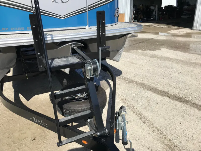 Slide: The Image of 2023 Avalon LSZ Elite Windshield boat trailer hitch and ladder on concrete surface. - 14
