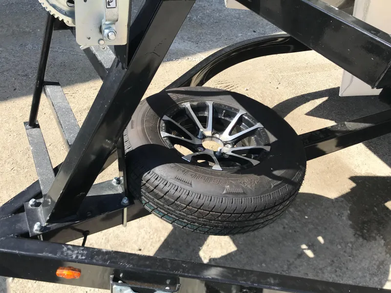 Slide: The Image of 2023 Avalon LSZ Elite Windshield trailer with spare tire mounted on black metal frame. - 17