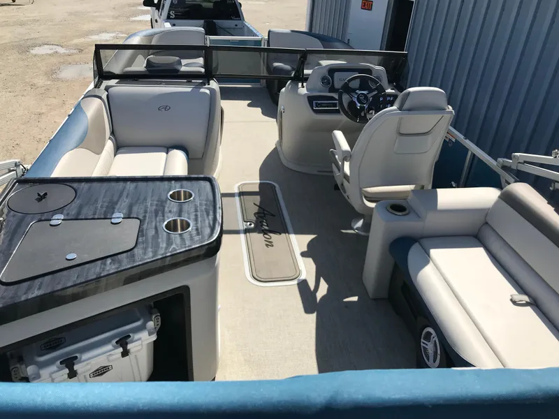Slide: The Image of 2023 Avalon LSZ Elite Windshield boat interior with seating and steering console. - 19