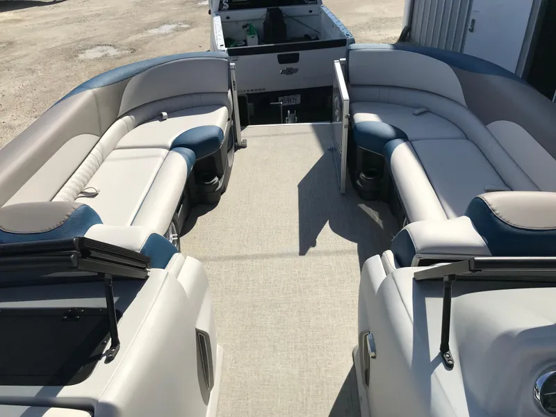 Slide: The Image of 2023 Avalon LSZ Elite Windshield pontoon boat interior with spacious seating and modern design. - 23