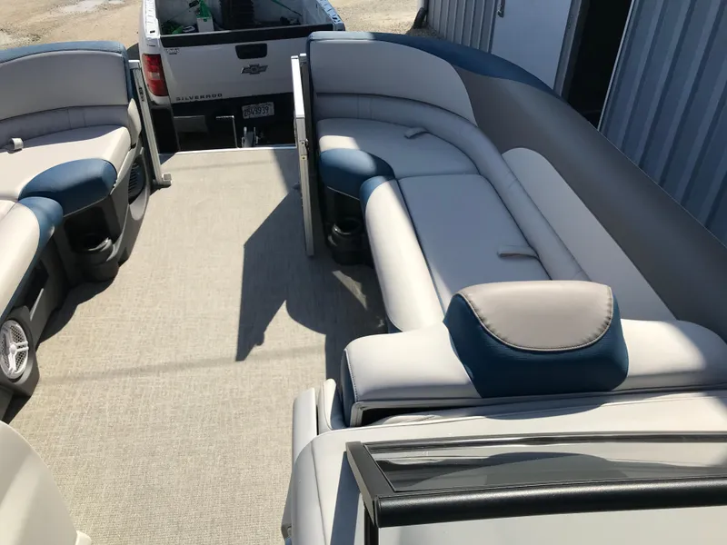 Slide: The Image of 2023 Avalon LSZ Elite Windshield pontoon boat interior with plush seating and spacious layout. - 24