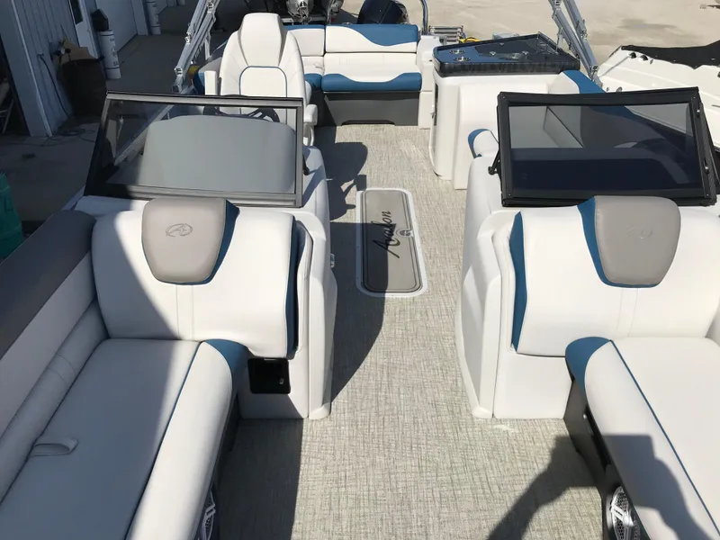 Slide: The Image of 2023 Avalon LSZ Elite Windshield boat interior with white and blue seating. - 27