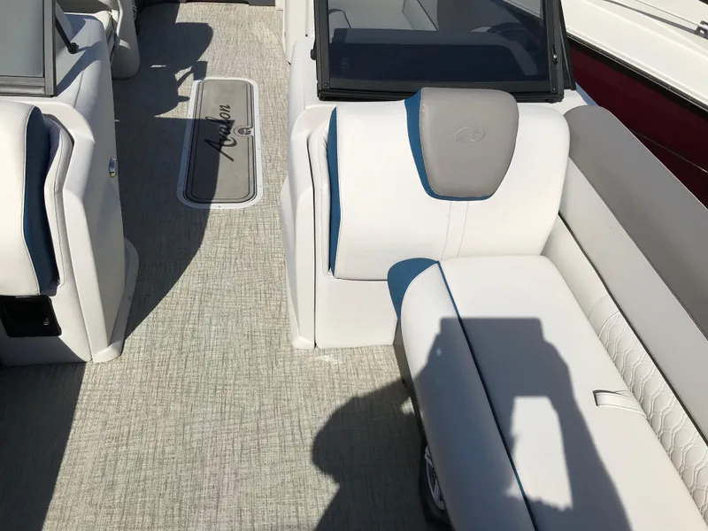 Slide: The Image of 2023 Avalon LSZ Elite Windshield boat interior with white seating and gray flooring. - 29