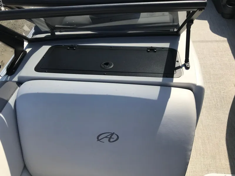 Slide: The Image of 2023 Avalon LSZ Elite Windshield boat interior with logo and storage compartment. - 40