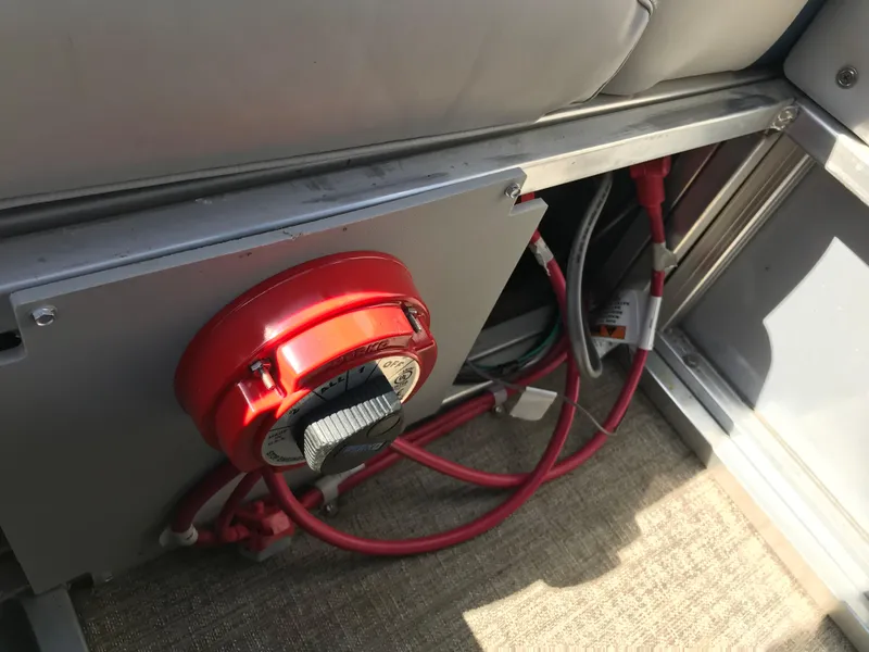 Slide: The Image of 2023 Avalon LSZ Elite Windshield boat interior with red battery switch and wiring. - 44