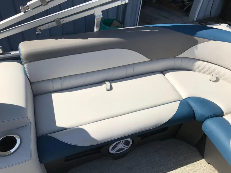 Slide: The Image of 2023 Avalon LSZ Elite Windshield boat interior with cushioned seating and cup holder. - 46
