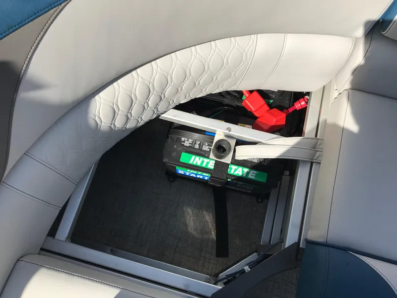 Slide: The Image of 2023 Avalon LSZ Elite Windshield boat battery compartment with visible Interstate battery. - 47