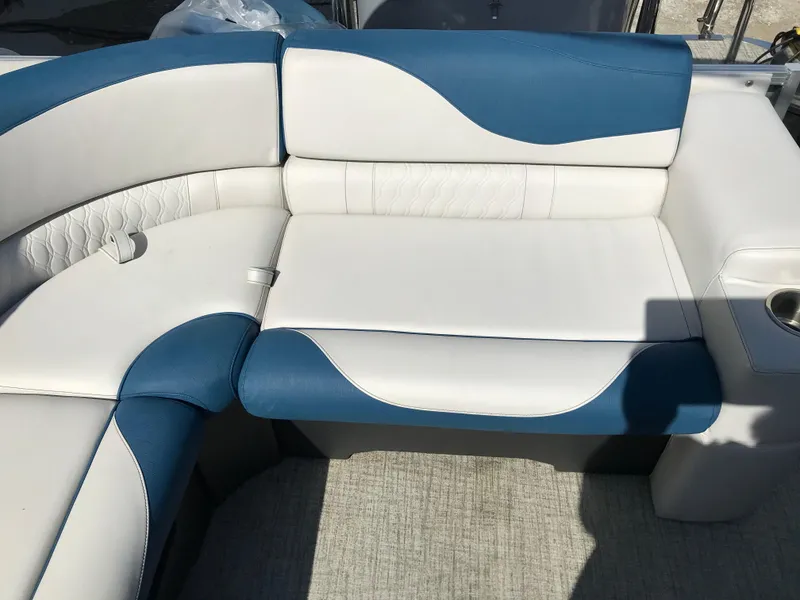 Slide: The Image of 2023 Avalon LSZ Elite Windshield boat seating with blue and white upholstery. - 48