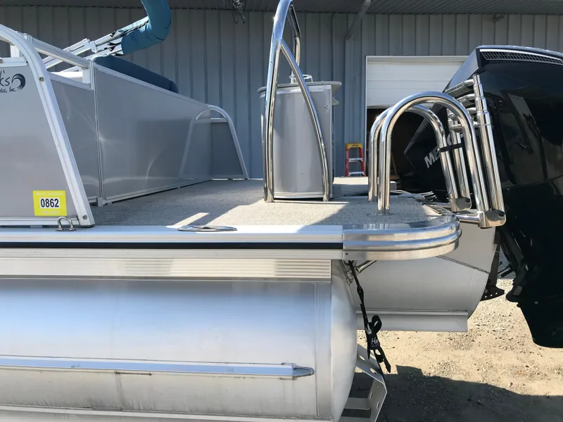 Slide: The Image of 2023 Avalon LSZ Elite Windshield pontoon boat with stainless steel ladder and Mercury outboard motor. - 5
