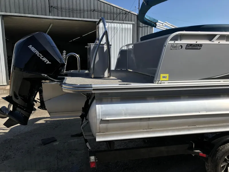 Slide: The Image of 2023 Avalon LSZ Elite Windshield pontoon boat with Mercury outboard motor. - 9