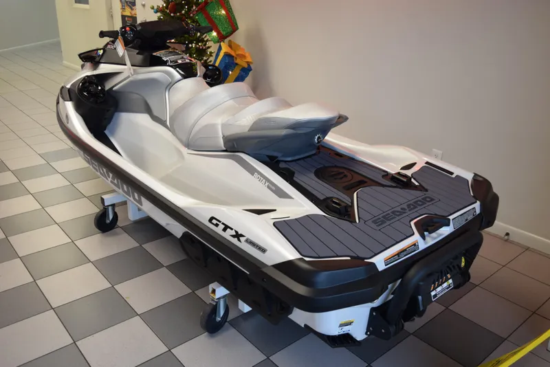 Slide: The Image of 2024 Sea-Doo GTX Limited 300 jet ski displayed indoors on tiled floor. - 4