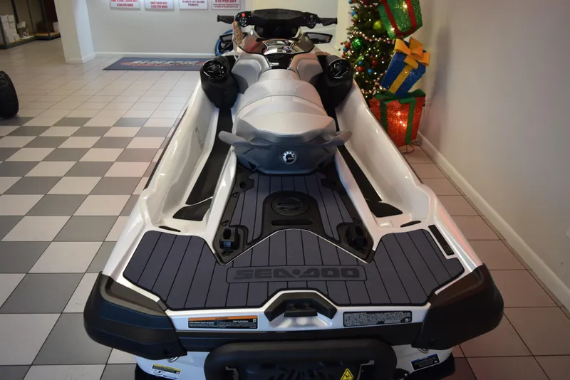 Slide: The Image of 2024 Sea-Doo GTX Limited 300 jet ski displayed indoors with holiday decorations. - 5