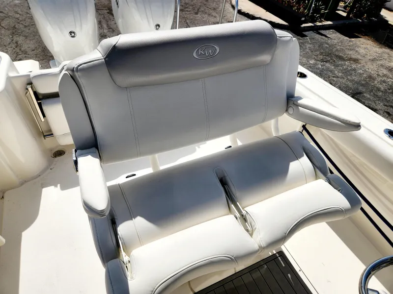 Slide: The Image of 2024 Key West 244 CC boat seating with cushioned armrests and backrest. - 14
