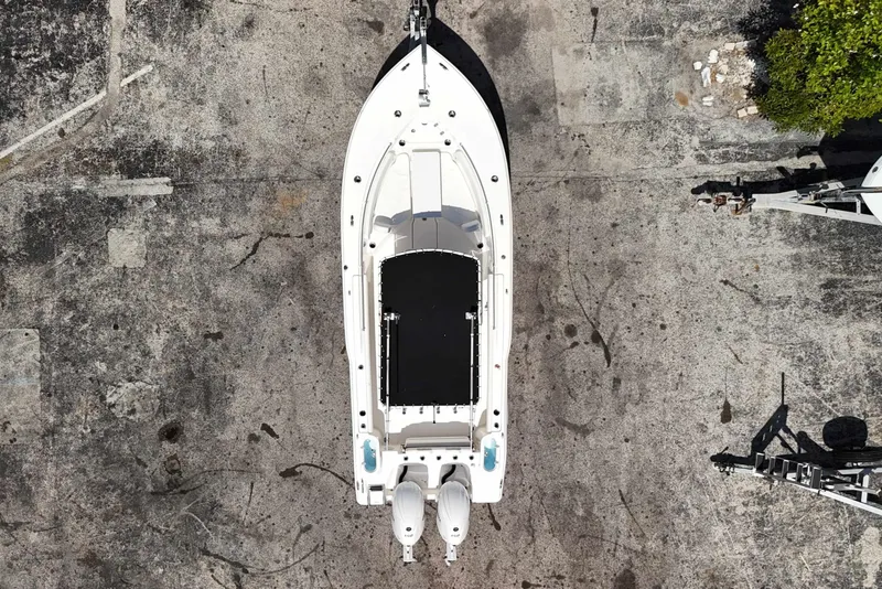 Slide: The Image of 2024 Key West 244 CC boat, aerial view, docked on concrete surface. - 16